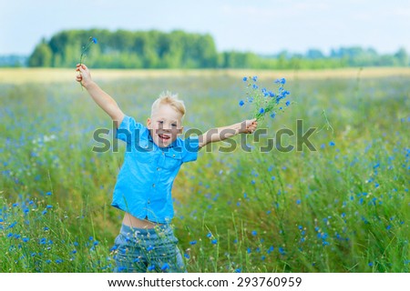 Boy Jumping In A Filed Of Wild Flowers
