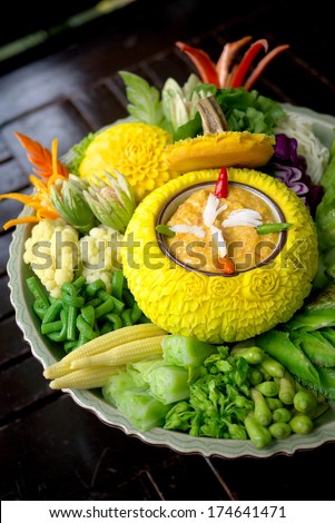 Crab roe chili paste in Thai craved pumpkin bowl served with fresh vegetables
