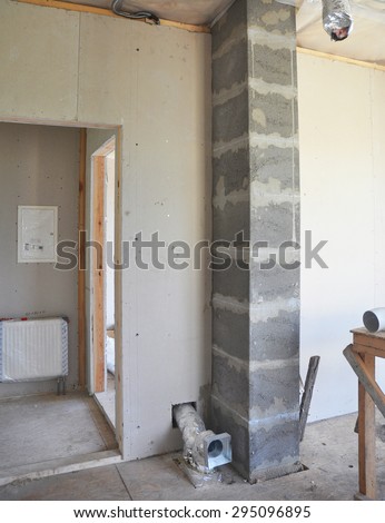 Building new modular chimney from pumice stone blocks inside room with ventilation system