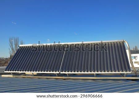 Energy  efficiency concept. Closeup of vacuum solar water heating system on the house  metal roof.