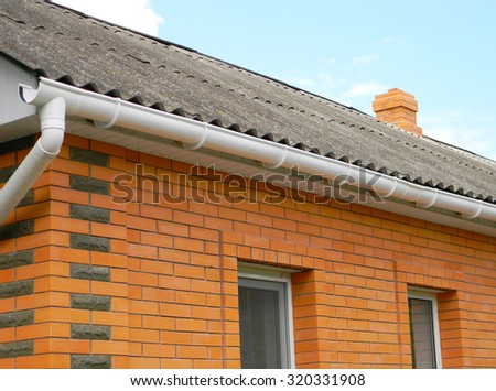Asbestos roof with plastic rain gutter