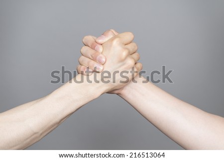 Hand holding hand isolated over gray background - Friendship, Shaking hands Business, Congratulation