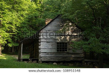 A historic cabin is surrounded by woods in the Smoky Mountain National Park.