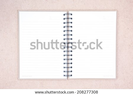 Blank Spiral Notebook with Line Paper on wood background