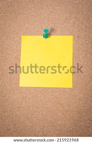 Yellow note on corkboard background