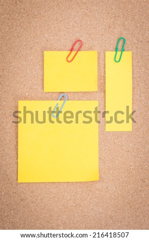 Yellow note on corkboard background