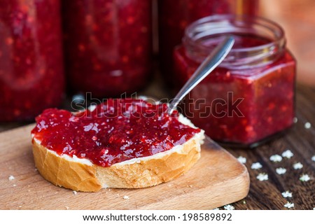 Strawberry jam in jar and on bread