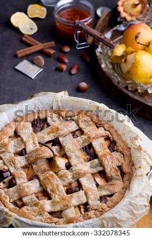 Apple/pear pie in a baking pan, with ingredients.