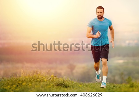 Athletic young man running in the nature. Healthy lifestyle