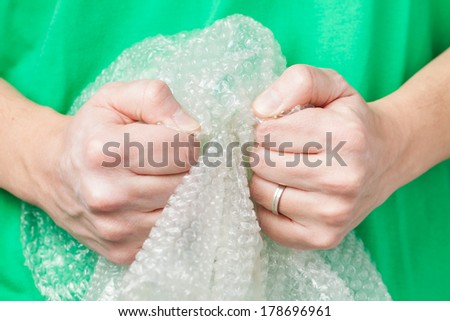 Man holding bubble wrap, stress relief