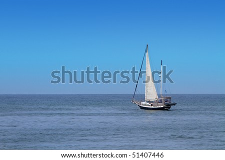 Solitary sailboat at sea on Pacific Ocean.