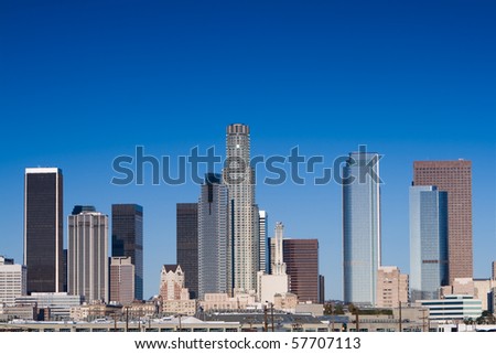 Los Angeles skyline on a sunny day with blue sky.