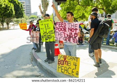 LOS ANGELES- OCTOBER 8: Protesters stand on the corner with signs of their cause in downtown Los Angeles at City Hall on October 8, 2011.