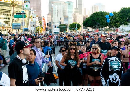 LOS ANGELES - OCTOBER 30: Costumed Participants head for the starting line in the Rock \'n Roll Marathon at LA Live in Los Angeles on October 30, 2011.