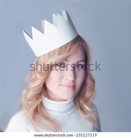 Beautifull woman in a paper crown. Queen. New Year celebration. Blond woman