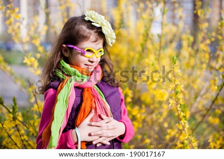 Beautiful girl in funny glasses in yellow flowers