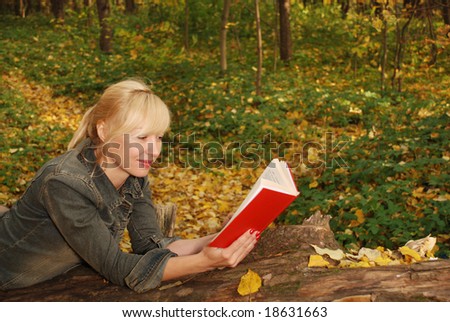 Reading woman in the autumn forest