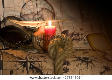 Dark image Old map, a candle and the rope inkwell