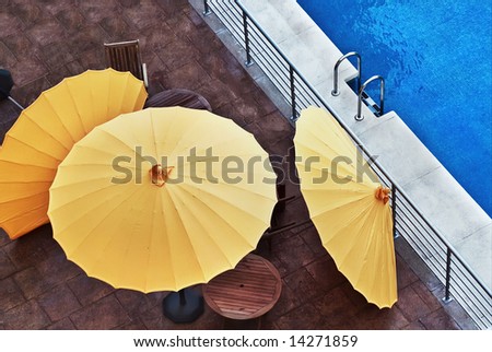The empty pool, the fallen parasols, recently protecting people from scorching solar beams. Has become cold. The tourist season has ended.