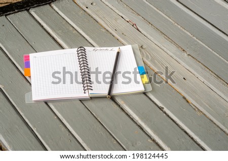 Notebook journalist or writer on the gray bench