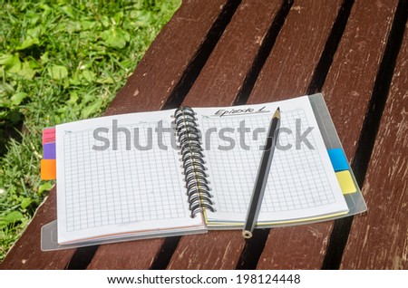 Notebook journalist or writer on the brown bench