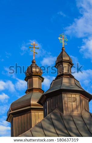 Orthodox church cupolas with colourful crosses against the blue sky
