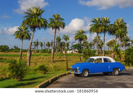 TRINIDAD, CUBA - DECEMBER 8, 2013: Typical view of classic blue American car on Cuban village where old vehicles become iconic part of Cuba landscape after Revolution in 1960s.