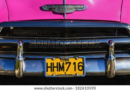 HAVANA, CUBA - DECEMBER 2, 2013: Hood classic shiny pink American car in the old town of Havana.