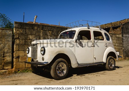 TRINIDAD, CUBA - DECEMBER 8, 2013:White American car in Trinidad, where old cars are relic of Cuban revolution and still attracts tourists