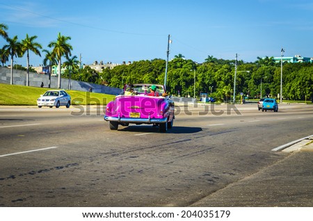 HAVANA, CUBA - DECEMBER 2, 2013: Old classic American pink cabriolet on one of Havana's main streets