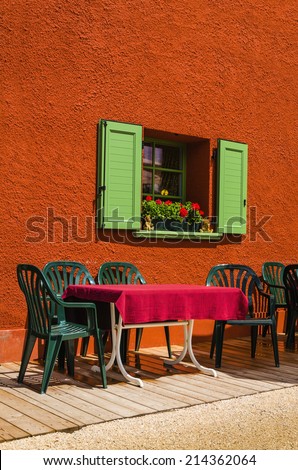 Sunny terrace table chair restaurant with mountains view, Dolomites Mountains, Italy