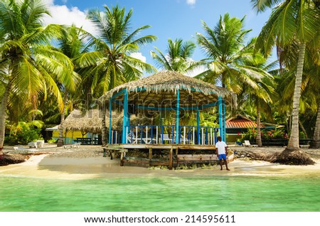 DOMINICAN REPUBLIC PUNTA CANA JANUARY 14 2014 Beach hut on coast of the exotic island full of palm trees DOMINICAN REPUBLIC PUNTA CANA JANUARY 14 2014 Beach hut on coast of the exotic island full of palm trees