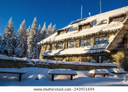 POLAND, GORCE - JANUARY 6, 2015 Mountain hiking shelter with ice on roof in winter scenery, Turbacz, Gorce Poland