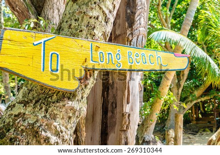 To Long Beach sign, wooden direction sign on the beach