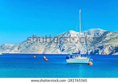 White yacht moored in sea bay of Greek Island, Greece