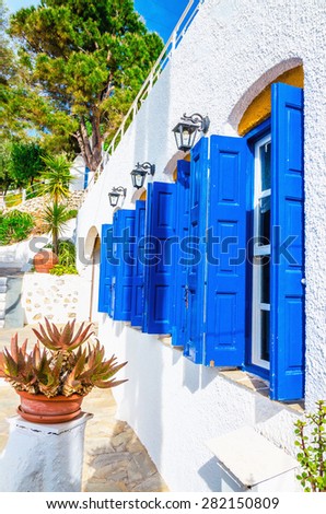 Iconic blue wooden shutters and white walls typical for Greece