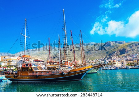 KALYMNOS, GREECE - MAY 01, 2015: Big Wooden yacht anchored in port of Pothia, Kalymnos, southern Greece