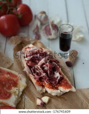 Bread with rubbed tomato, rubbed garlic and jam . Typical snack from Catalonia (Spain)