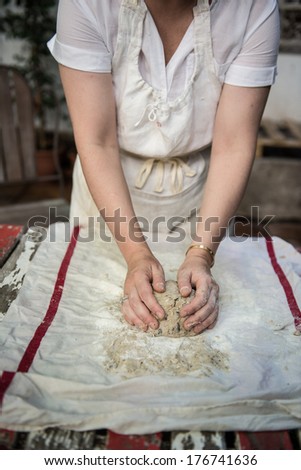 Girl kneading bread.