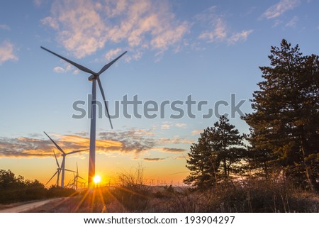Wind turbines at dawn over a colorful sky