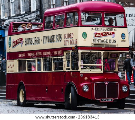 Edinburgh, Scotland - September 14, 2014: Charming vintage double decker bus is about to begin a new city tour. Painted in striking red and yellow colors, the bus roam the city loaded with tourists.