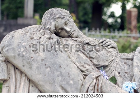 Old statue woman on grave in the Lychakivskyj cemetery of Lviv, Ukraine.