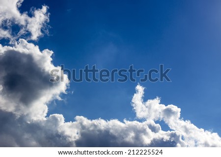 Blue sky with white cloud closeup. Abstract cloudscape art background. Photographic cloudy environment