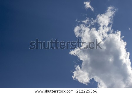 Blue sky with white cloud closeup. Abstract cloudscape art background. Photographic cloudy environment