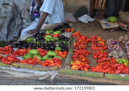 STONE TOWN, ZANZIBAR - DECEMBER 12: Sellers offer fruit and vegetables in the city market on 12 December 2013 in Stone Town, Tanzania.