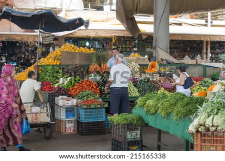 AGADIR, MOROCCO - AUGUST 28: Sellers offer fruit and vegetables in the Suk - city market  on 28 August 2014 in Agadir, Marocco