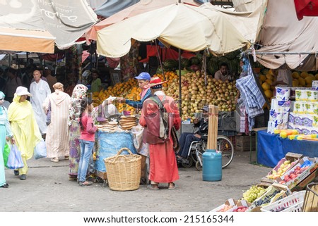 AGADIR, MOROCCO - AUGUST 28: Sellers offer fruit and vegetables in the Suk - city market  on 28 August 2014 in Agadir, Marocco