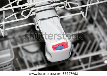Close-up of tablet in dishwasher detergent box