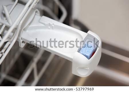Close-up of tablet in dishwasher detergent box
