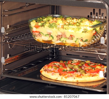 Baking pizza and casserole dish with bechamel sauce in oven. Hot air allows the burning of different dishes simultaneously.